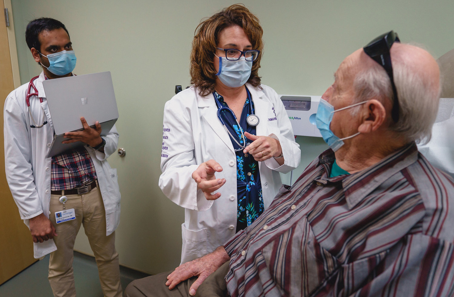 Dr. Linda Thomas-Hemak, president and CEO of the Wright Centers for Community Health and Graduate Medical Education, center, treats a patient at the Mid Valley Practice. A resident physician is participating in the primary care visit. ..